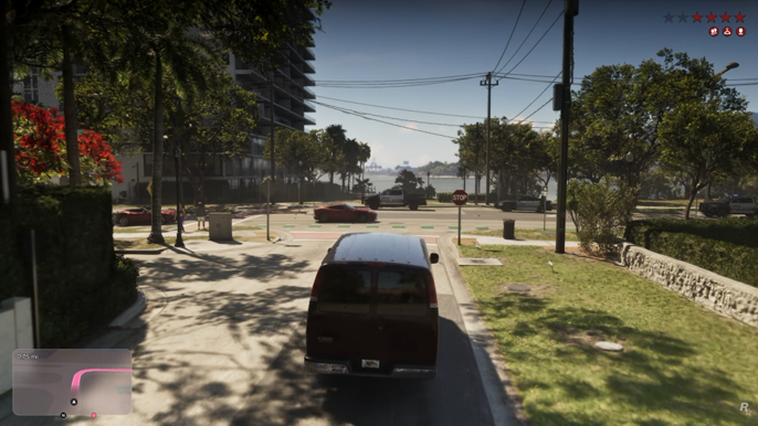 A brown van on a tree-lined street, with a red sports car ahead